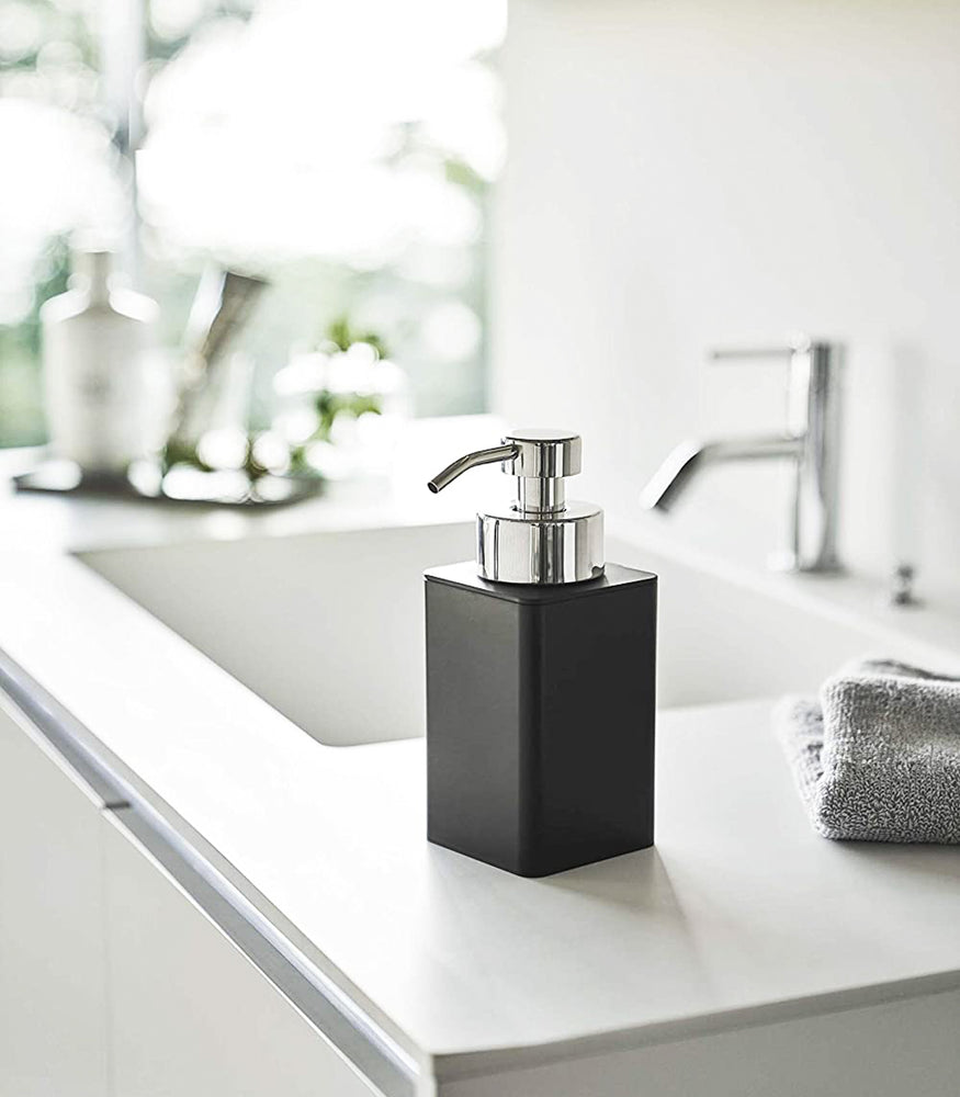 View 7 - Black Foaming Soap Dispenser on bathroom sink counter by Yamazaki Home.