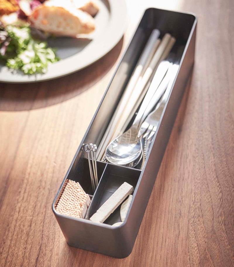 Black Utensil Case holding utensils and items on tabletop by Yamazaki Home.