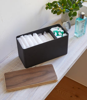Black Countertop Organizer holding diapers and items with cover off on shelf by Yamazaki Home. view 10