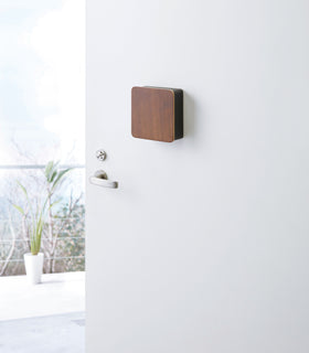 Closed black with wood Square Magnetic Key Cabinet on door by Yamazaki Home. view 10
