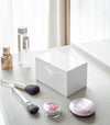 Closed white Skincare Organizer on vanity by Yamazaki Home.