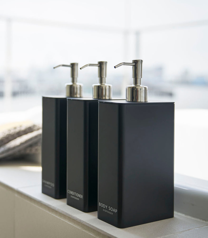 View 10 - Yamazaki Home black Shampoo, Conditioner, and Body Soap dispensers in bathroom.