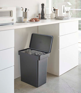 Open black Rolling Trash Can in kitchen by Yamazaki Home. view 10