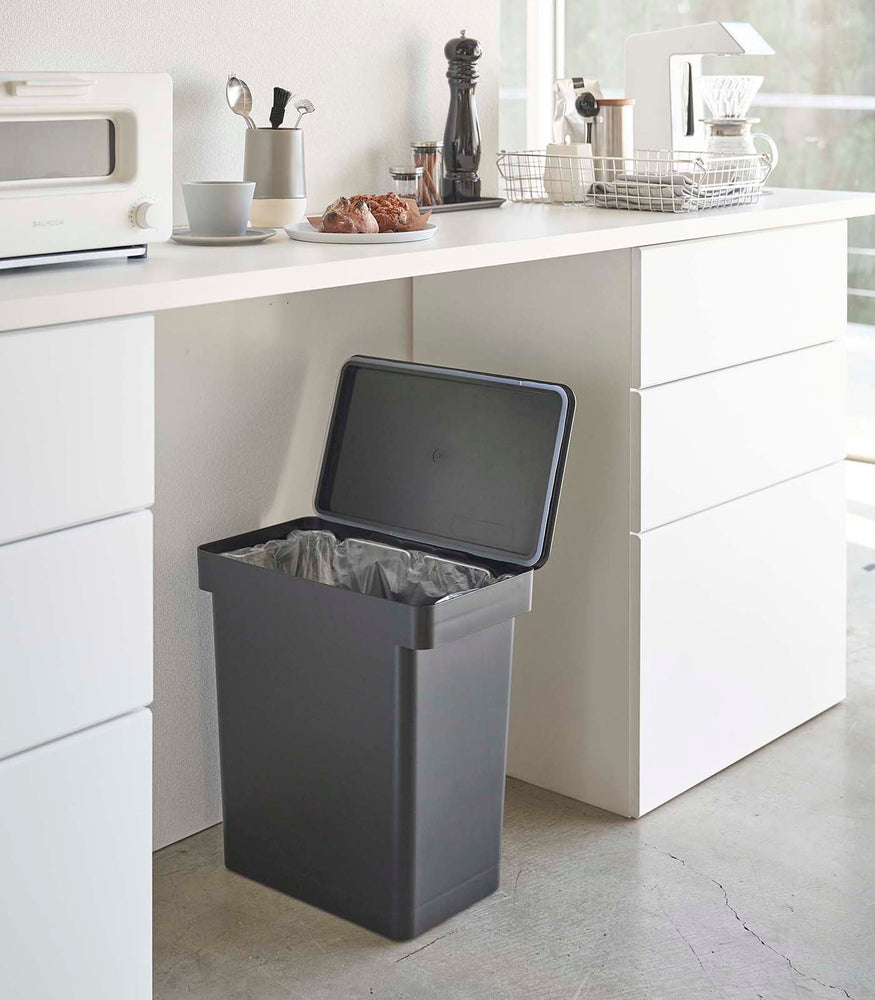 View 10 - Open black Rolling Trash Can in kitchen by Yamazaki Home.