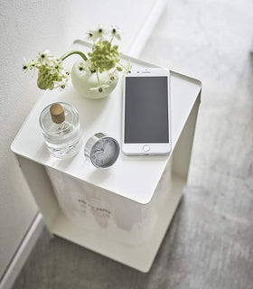 Aerial view of white Rolling Bathroom Organizer with décor on top and holding toilet paper in bathroom by Yamazaki Home. view 3