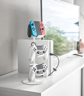 White Controller Stand holding game controllers on countertop by Yamazaki Home. view 2
