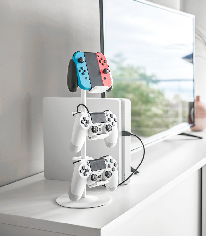 View 2 - White Controller Stand holding game controllers on countertop by Yamazaki Home.