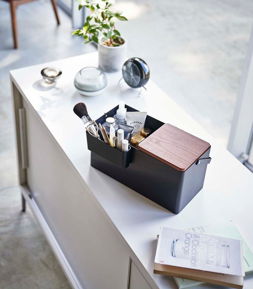 View 9 - Closed black Makeup Organizer holding makeup products on table by Yamazaki Home.