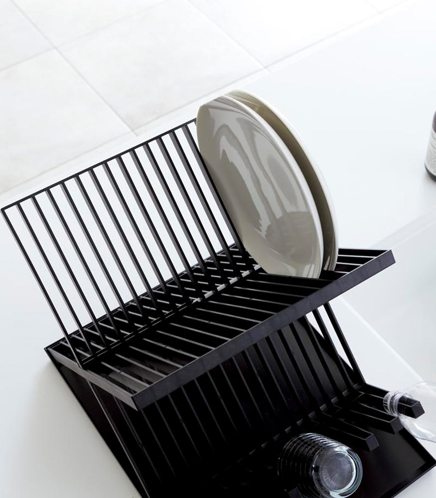 View 10 - Aerial view of Black X-Shaped Dish Rack holding plates and cups by Yamazaki Home.