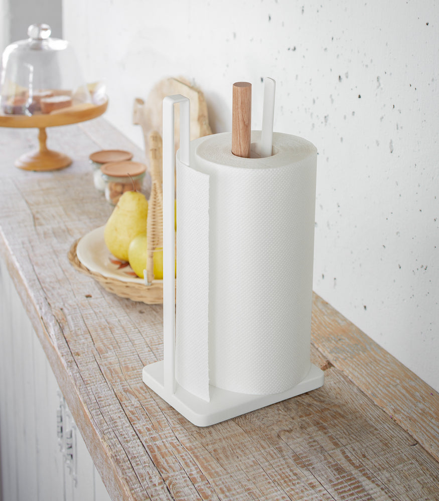 View 3 - Paper Towel Holder holding paper towel on shelf in kitchen by Yamazaki Home.